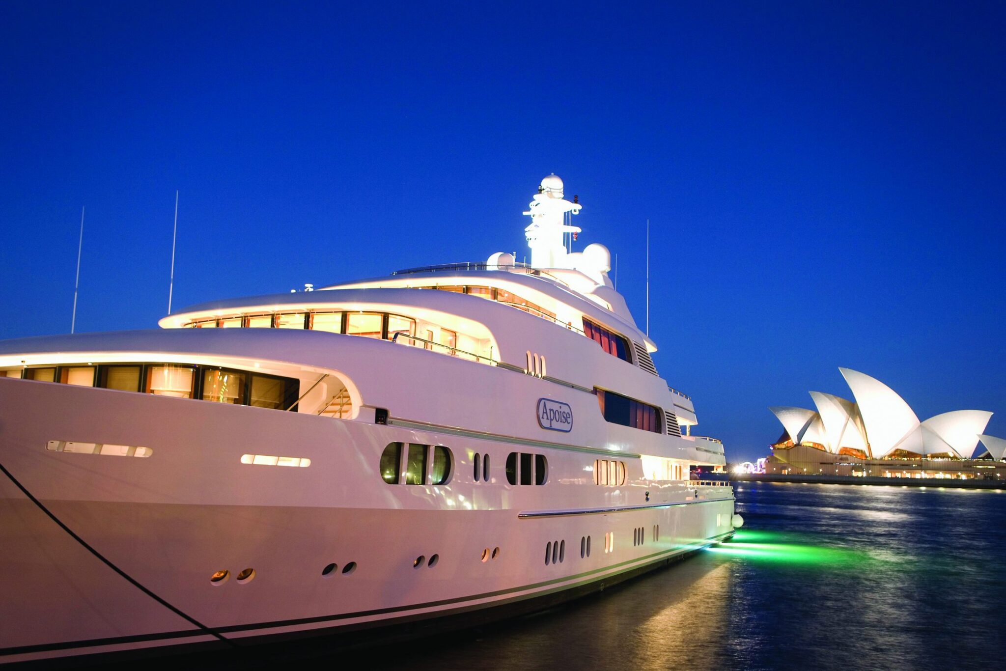 Superyacht lit up at night opposite the Sydney Opera House